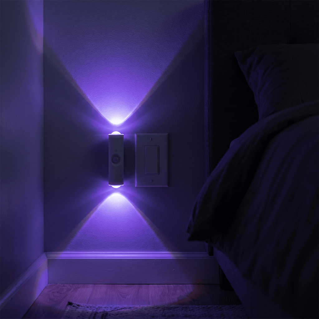 HaloBeam RGB wall light throwing purple up-and-down beams in a dark bedroom hallway