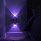 HaloBeam RGB wall light throwing purple up-and-down beams in a dark bedroom hallway