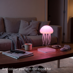 Jelly colour-changing jellyfish lamp glowing pink on a living room coffee table