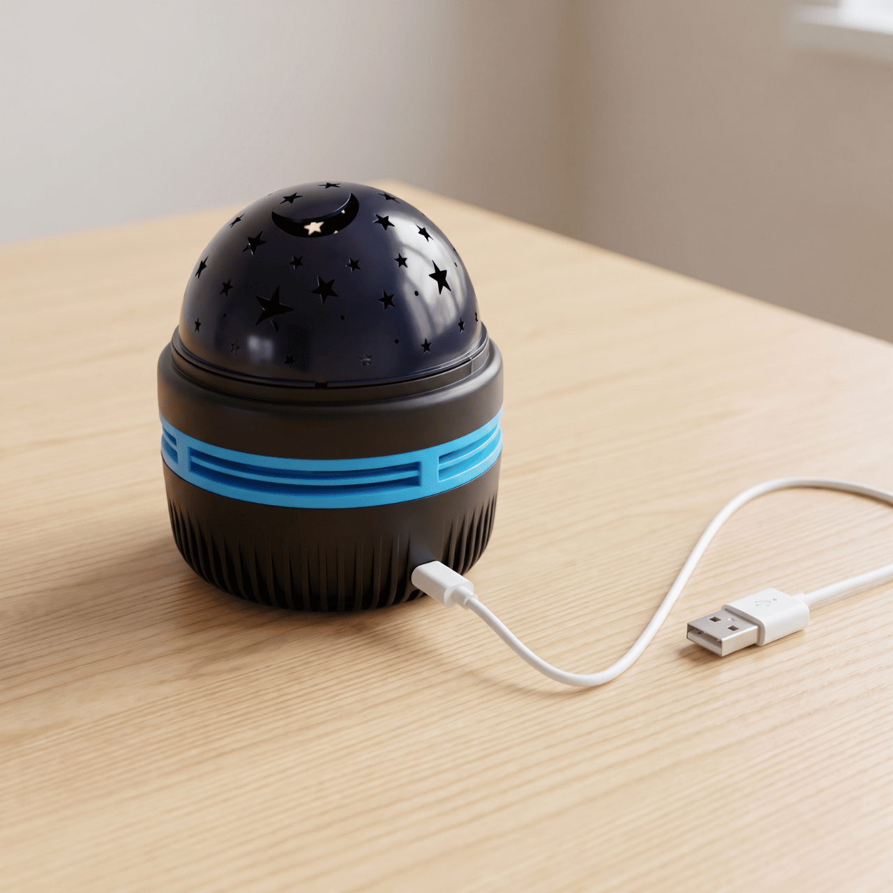 Starlull star projector on a wooden table with its white USB power cable