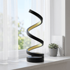 Spira spiral table lamp on a white windowsill in daylight beside sheer curtains and a small plant