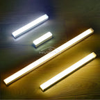 Three Nook Light motion sensor bars shown lit in cool white and warm white on a dark background