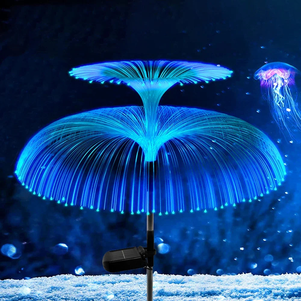 SeaBloom solar jellyfish garden lights glowing green and blue beside a garden path at night