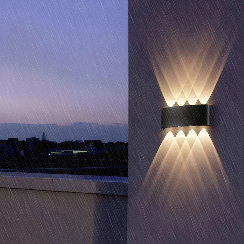Aura Beam wall light glowing on a balcony wall during heavy rain at dusk