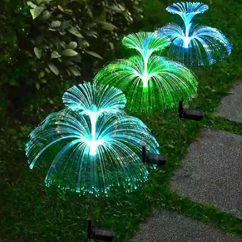 SeaBloom solar jellyfish garden lights lighting a garden border in the evening